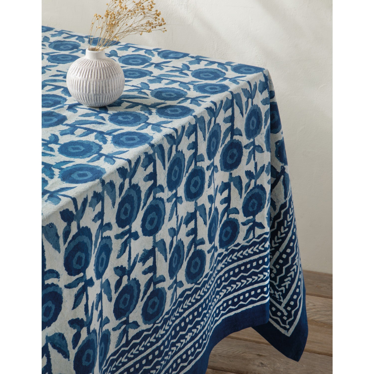Tablecloth with blue floral pattern on a wooden table