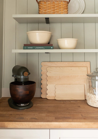 Add whimsical charm to your kitchen with this Scalloped Cutting Board. Handcrafted from solid maple wood and finished with a food grade oil, these cutting boards is a beautiful yet functional addition for daily use.