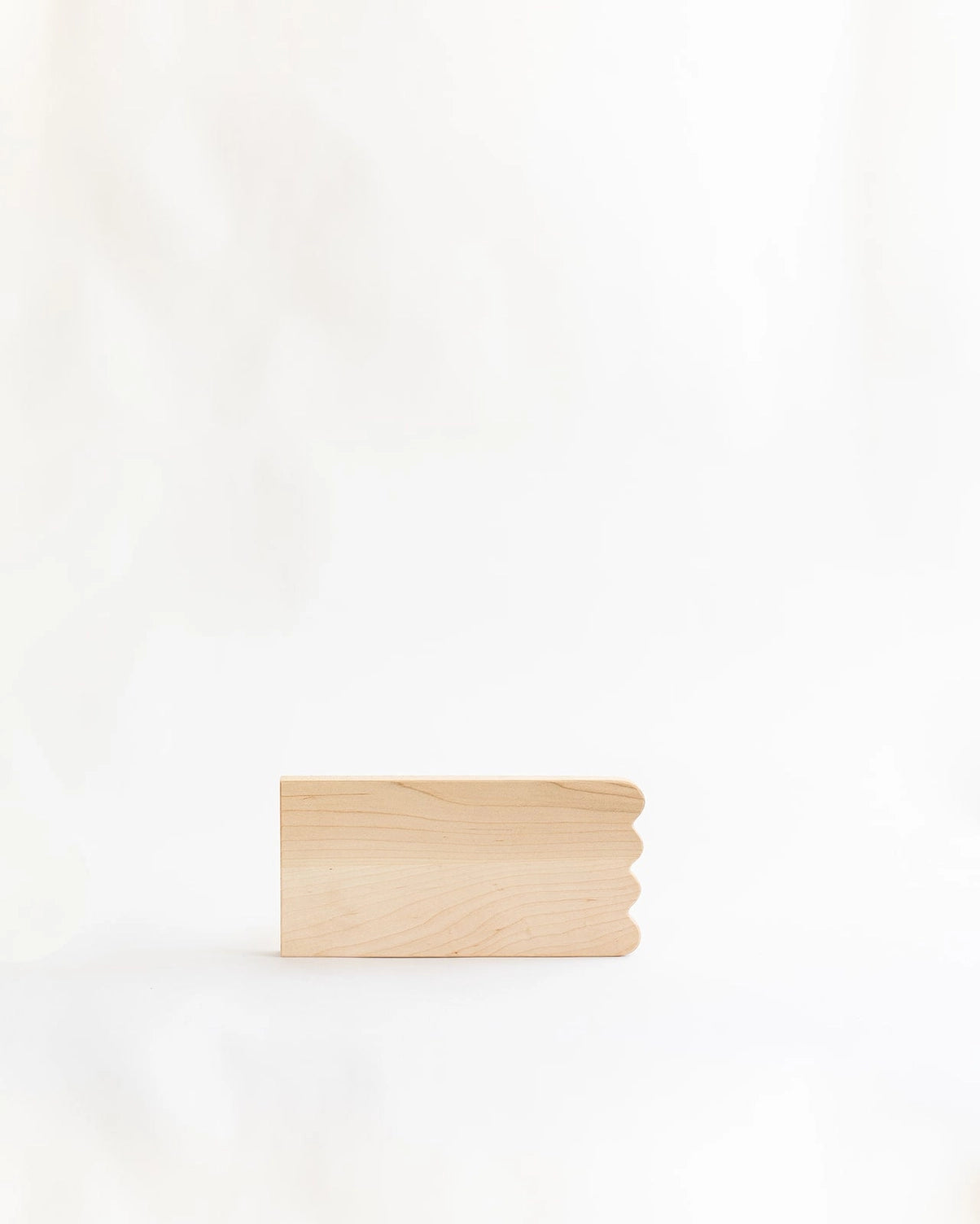 Add whimsical charm to your kitchen with this Scalloped Cutting Board. Handcrafted from solid maple wood and finished with a food grade oil, these cutting boards is a beautiful yet functional addition for daily use.