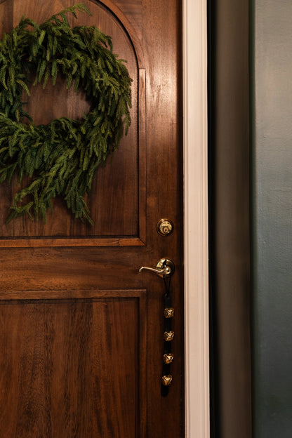 This cheery set of bells can be hung on a door handle for a merry sound to accompany all the holiday comings and goings. Made by Amish craftsman and out of leather and brass materials. Perfect for hanging from your front door.