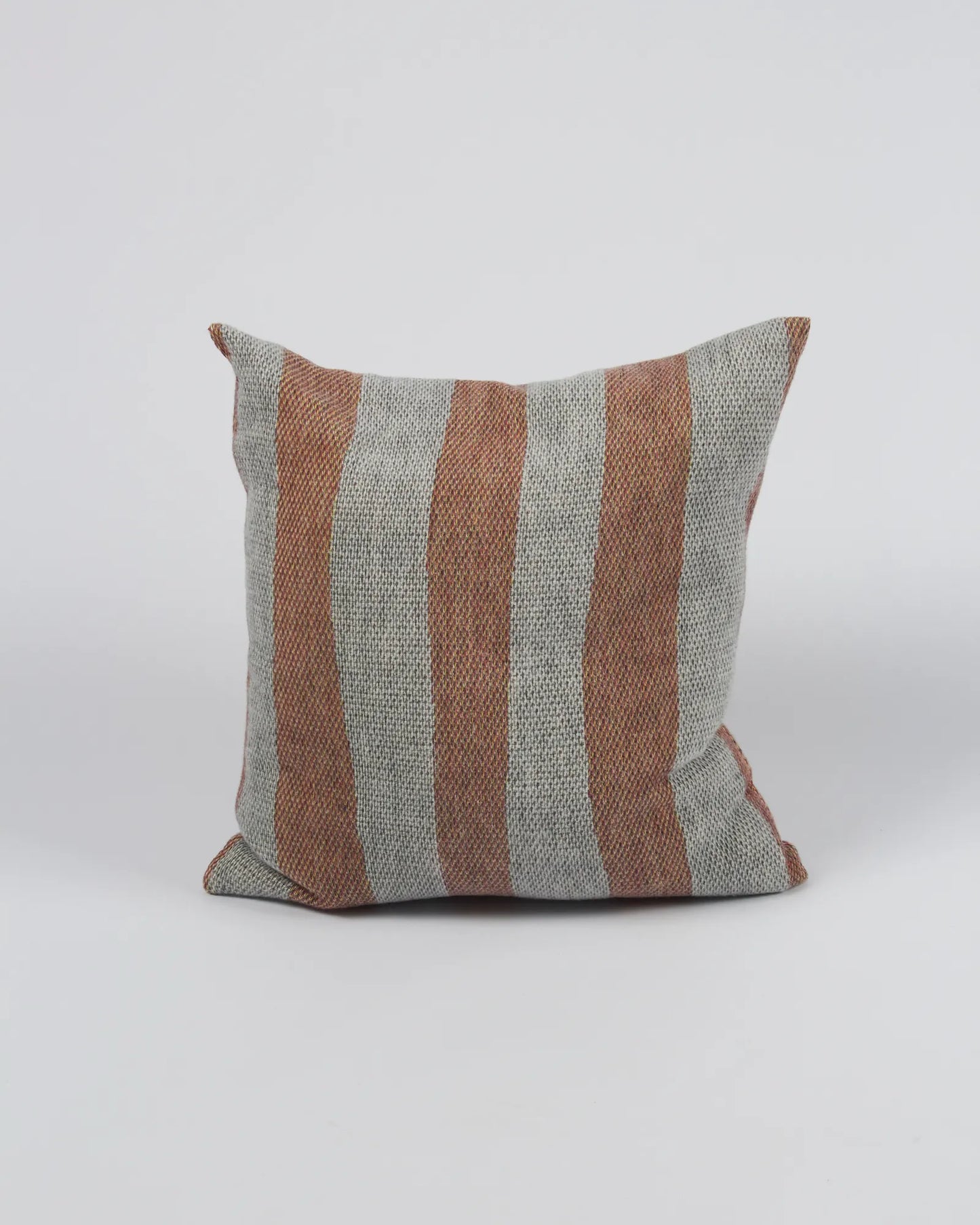 Striped pillow with brown and gray pattern on a white background