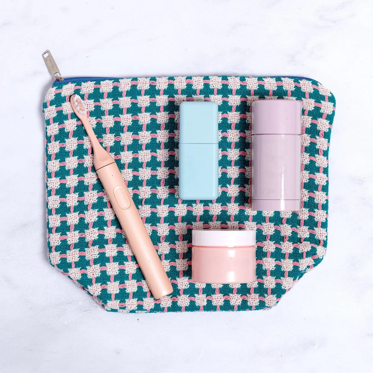 Cosmetic bag with skincare products on a white background