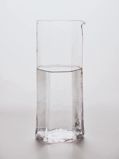 Water filled carafe on white background