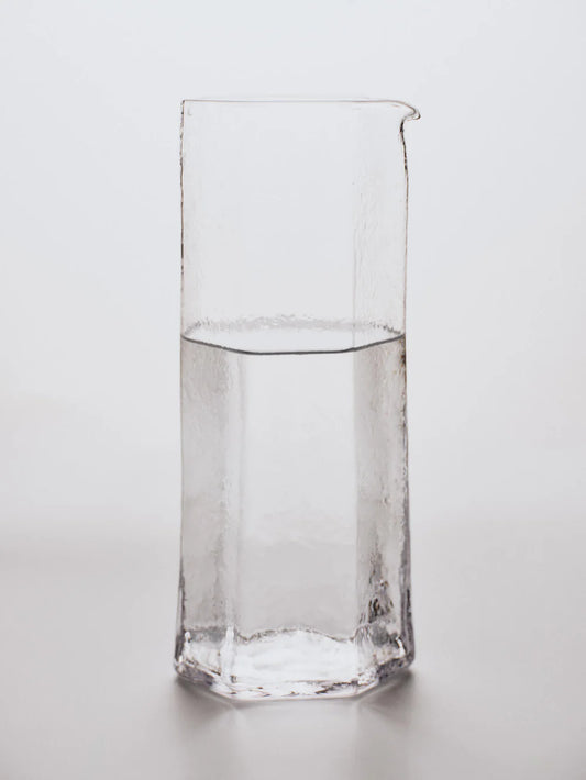 Water filled carafe on white background
