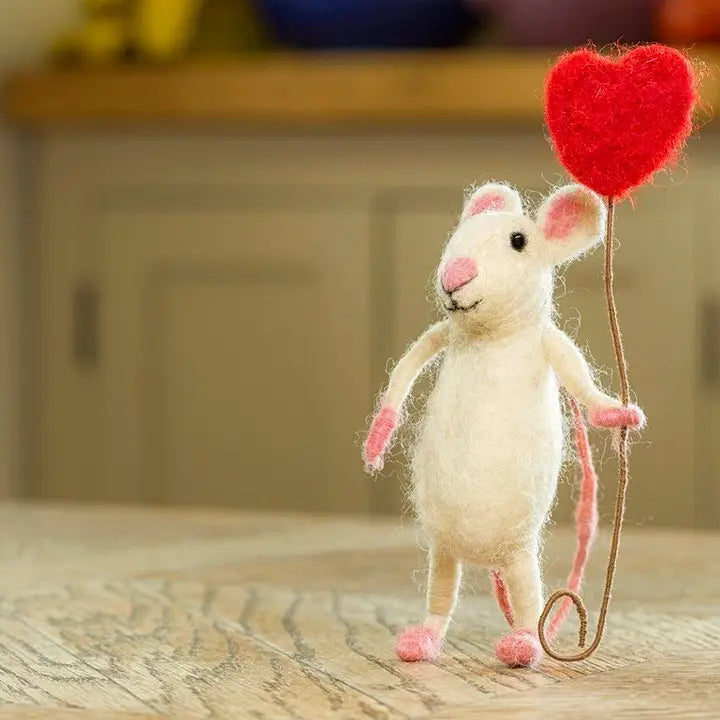 White mouse standing holding a red heart balloon