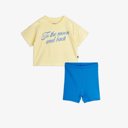 Yellow t-shirt with blue text and blue shorts on a white background