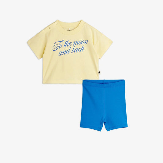 Yellow t-shirt with blue text and blue shorts on a white background