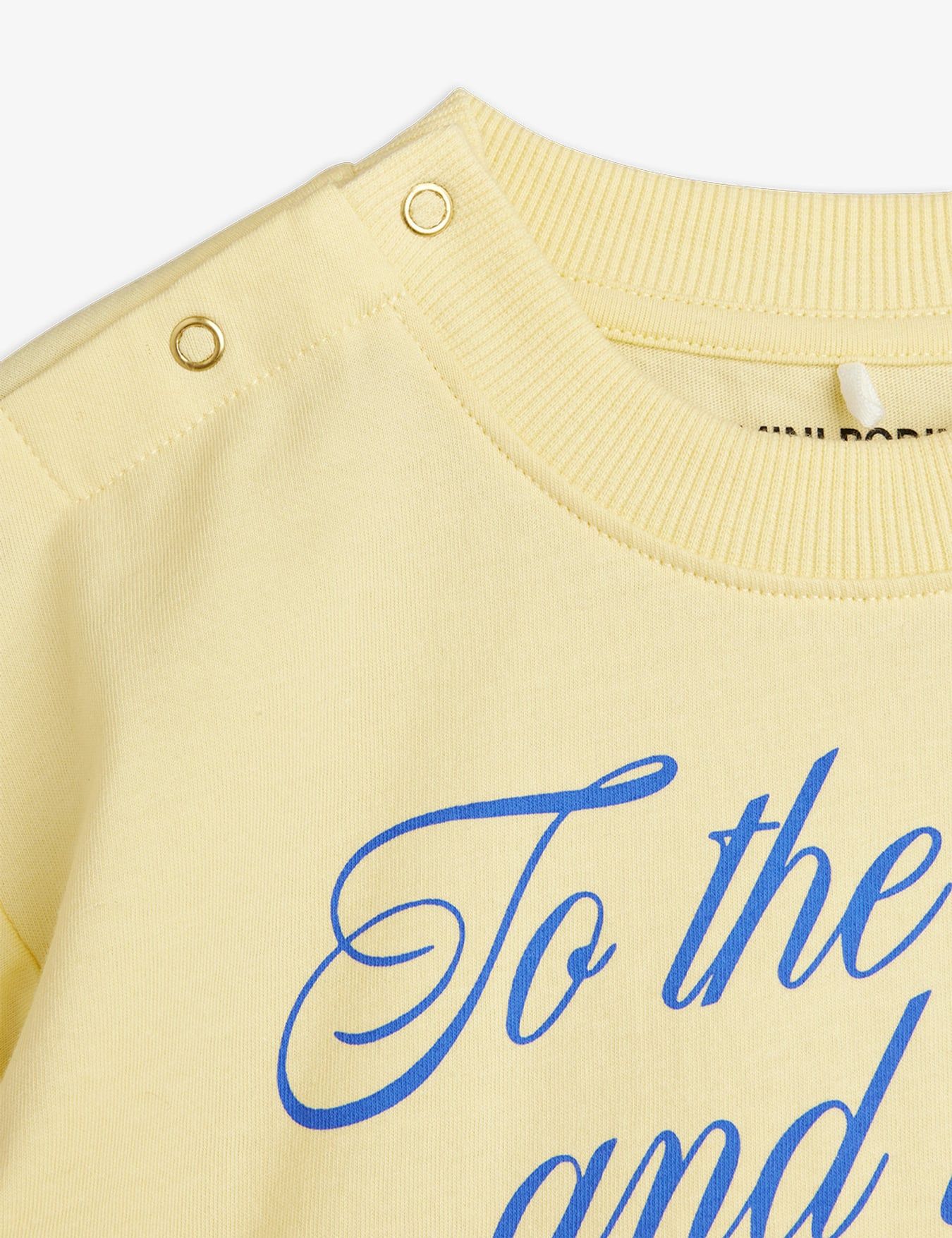 Yellow sweater with blue text on a white background