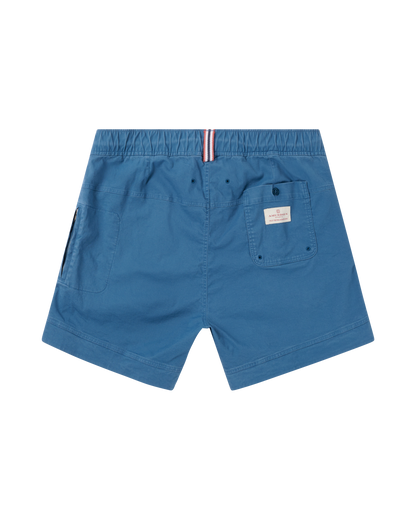Blue shorts with a small pocket and brand label on a white background