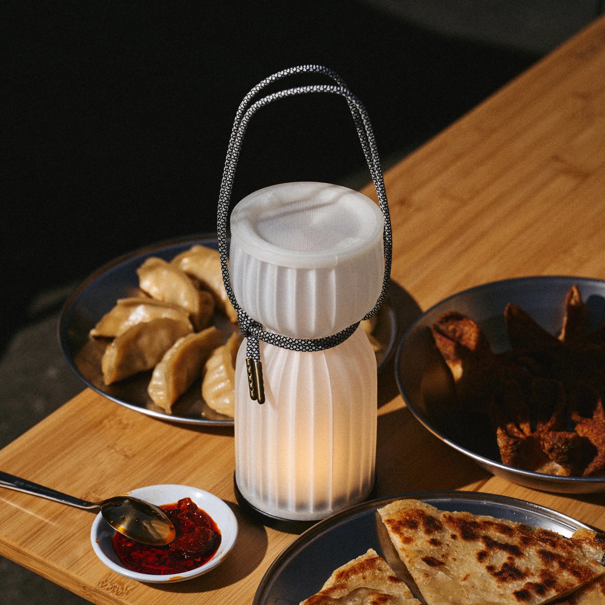 Initially inspired by the shape of water gourds and sake bottles, the Camp Lantern features a playful paracord sling handle, meant to encourage and highlight portability – hang it on a bedpost, take it on a picnic, or simply carry it with you around the house.&nbsp;
Cordless unit is USB-C rechargeable, features three dim-to-warm brightness settings, and lasts for up to 80 hours between charges.