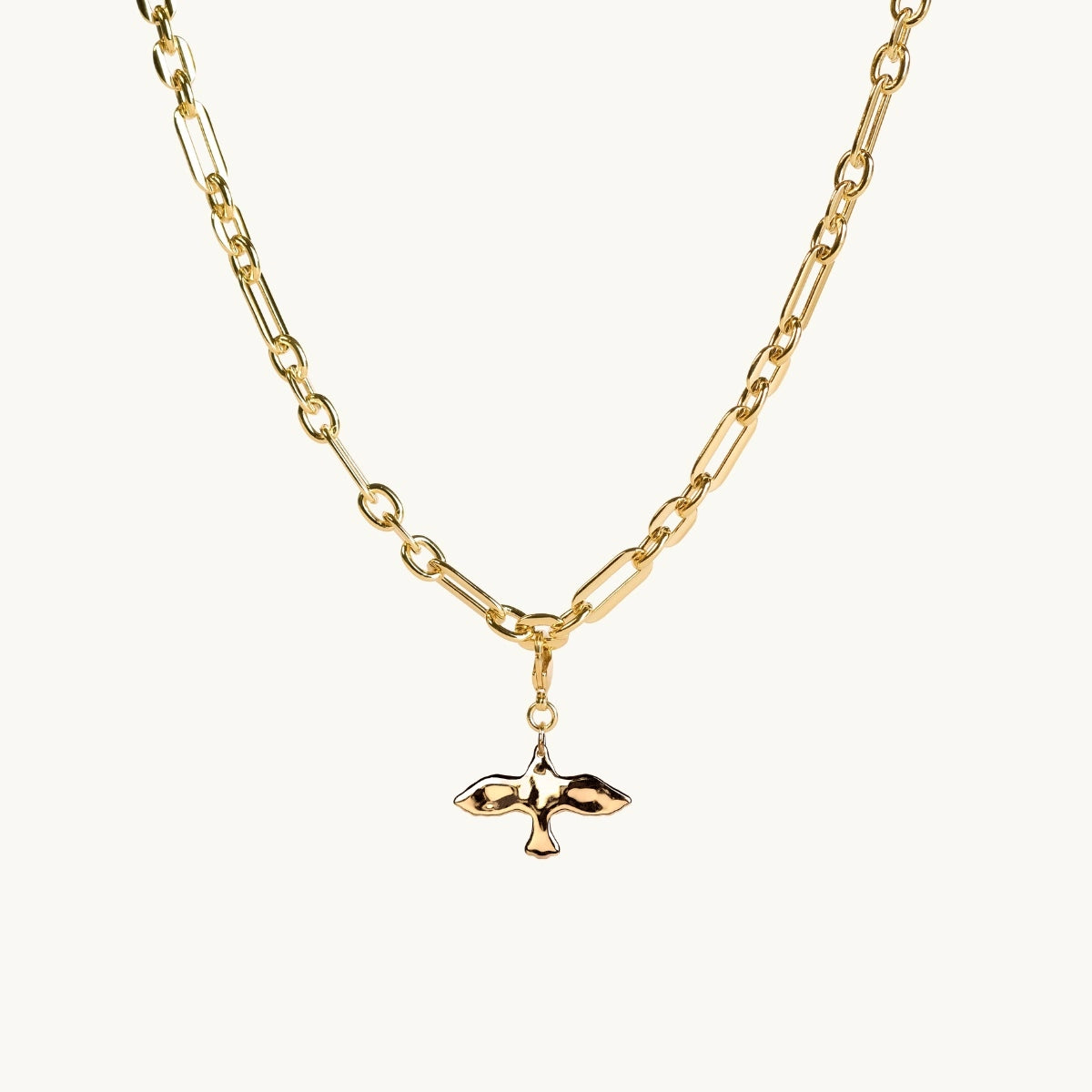 Gold necklace with a small dove pendant on a white background