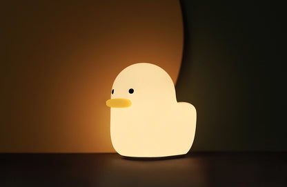 A small duck shaped night lamp designed to accompany you into sleep, a perfect LED night light as bedside table lamp, decoration for dorm, bedroom, nursery, and study room. It features adorable animal appearance, soft and smooth silicone material, comfortable warm yellow light, simple and time-delay switch for versatile and convenience use.