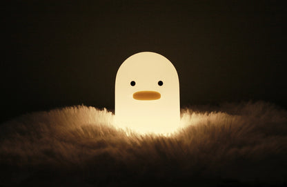 A small duck shaped night lamp designed to accompany you into sleep, a perfect LED night light as bedside table lamp, decoration for dorm, bedroom, nursery, and study room. It features adorable animal appearance, soft and smooth silicone material, comfortable warm yellow light, simple and time-delay switch for versatile and convenience use.