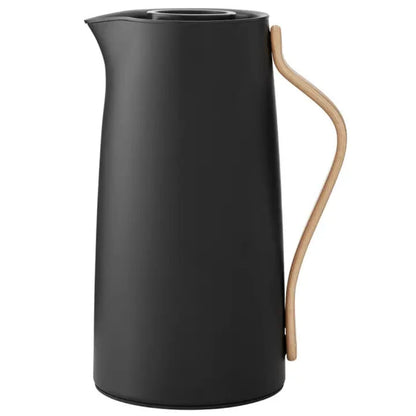 Black pitcher with a beige handle on a white background