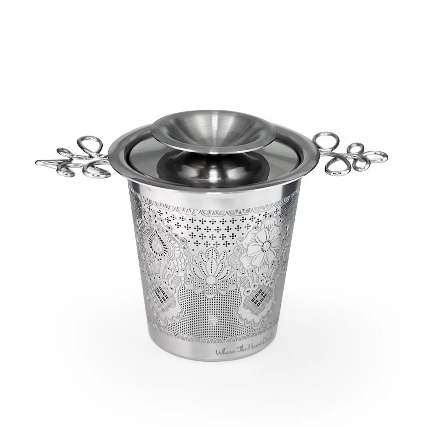 Decorative metal ice bucket with floral patterns on a white background
