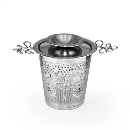 Decorative metal ice bucket with floral patterns on a white background