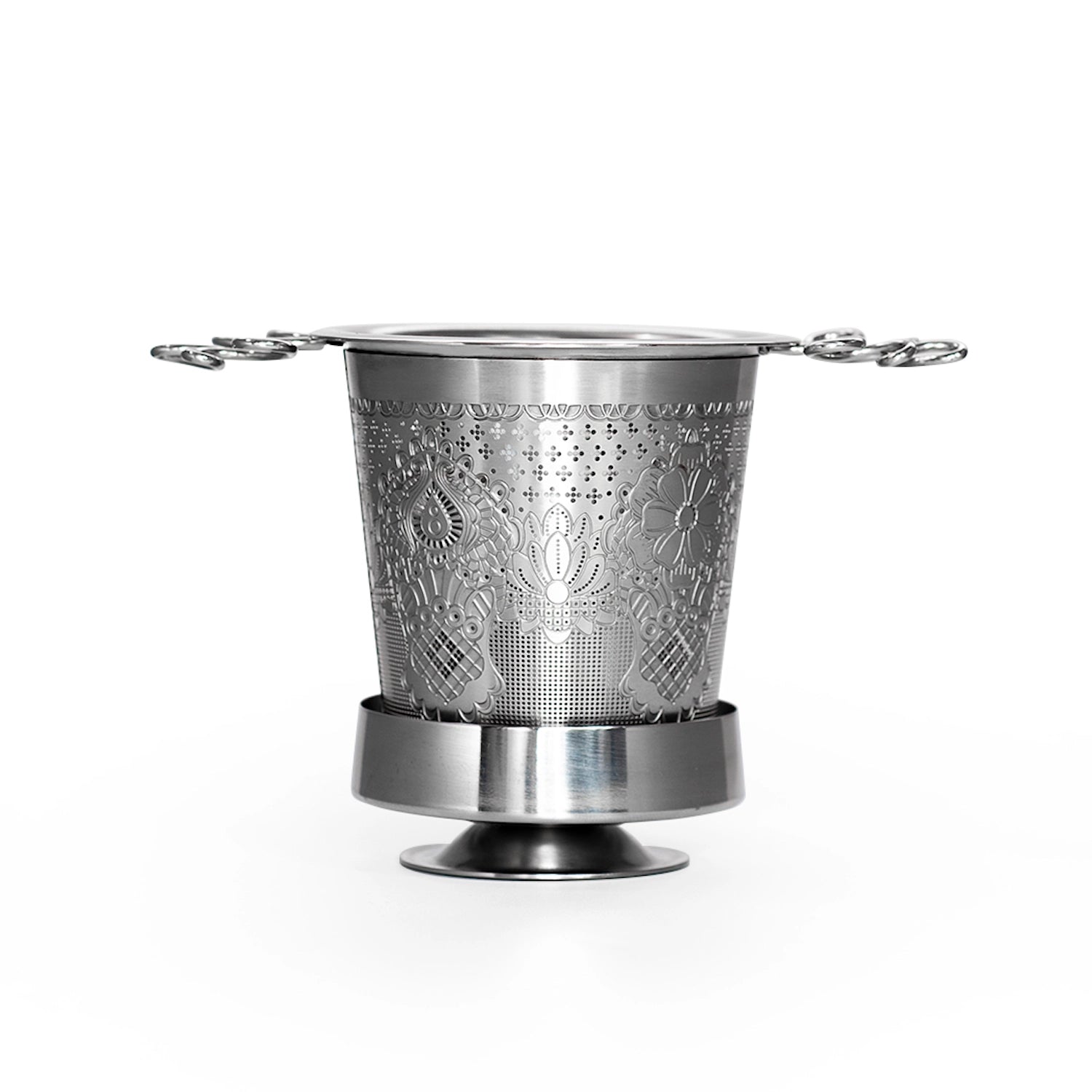 Metallic tea infuser with intricate design on a white background