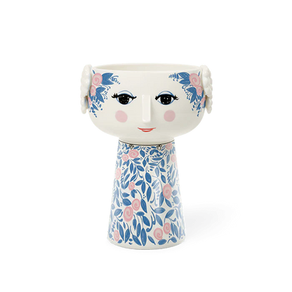 Decorative vase with floral design and face details on a white background
