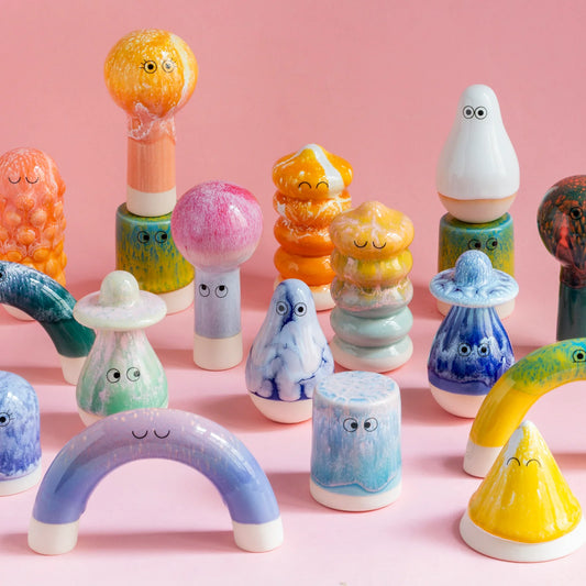 Studio Arhoj Familia on a pink background with lots of vibrant and beautiful glazes and fun eyeballs. They host a lot of personality and are great gifts to friends and family. You can pick one that looks cute, mischievous, anxious, or shocked. So much soul in each object.