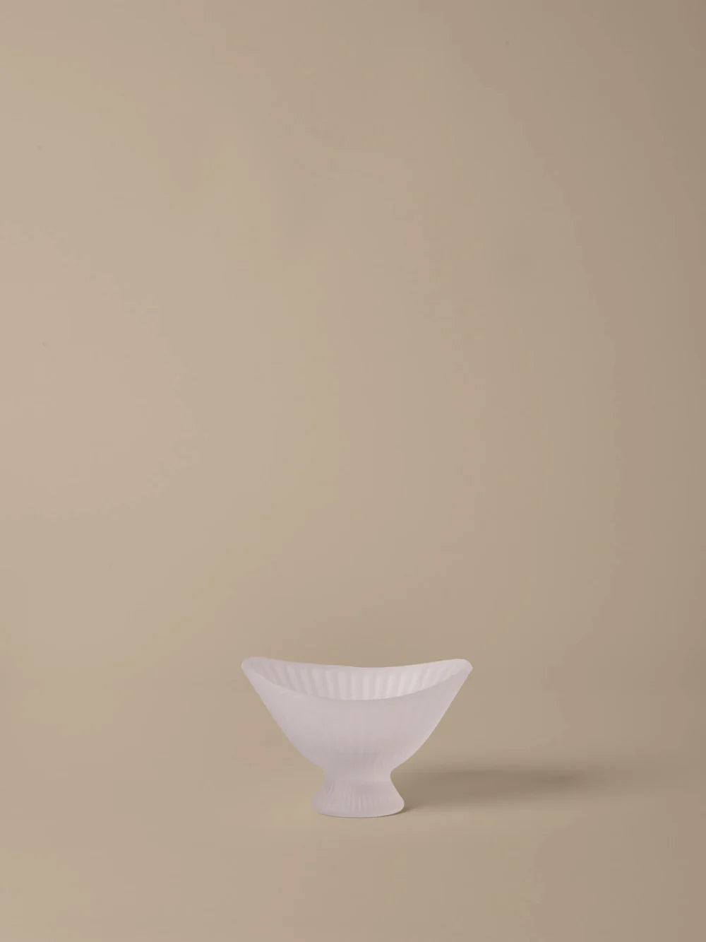 White ceramic bowl on a beige background
