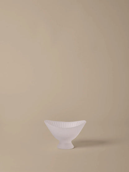 White ceramic bowl on a beige background