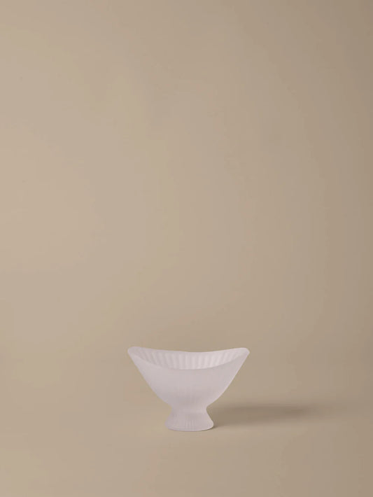 White ceramic bowl on a beige background