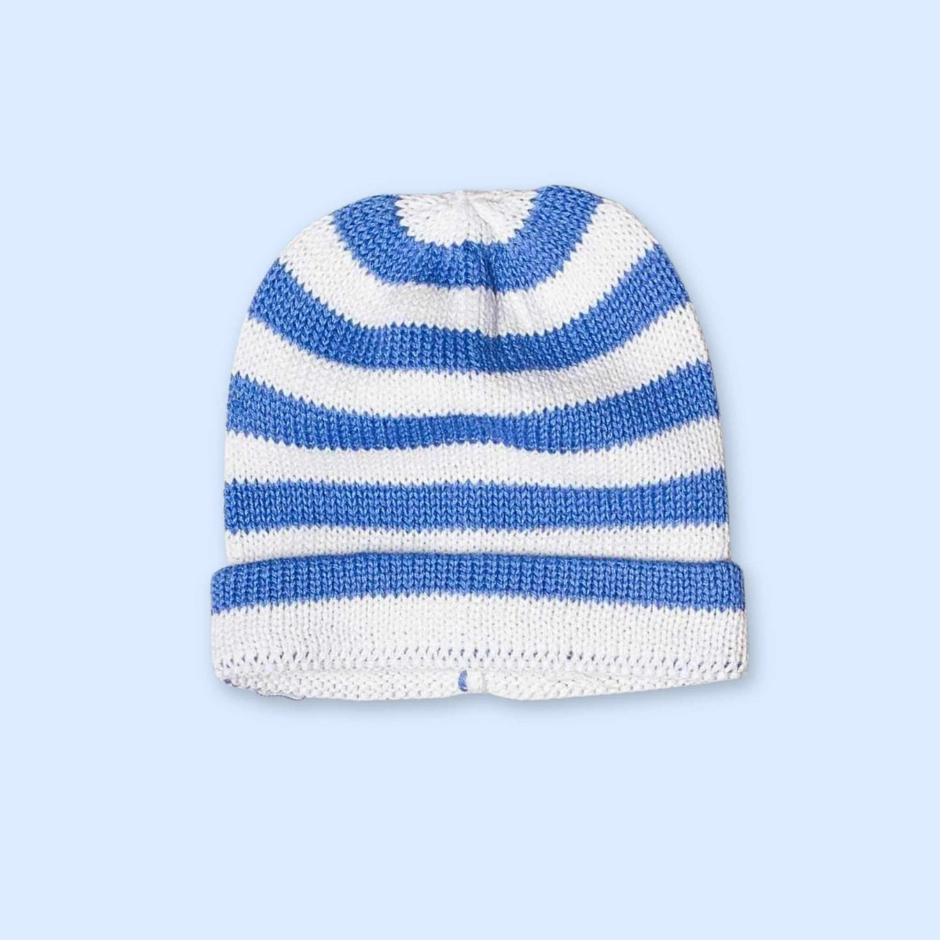 Organic baby gift set featuring a whale lovey, rattle, and striped hat