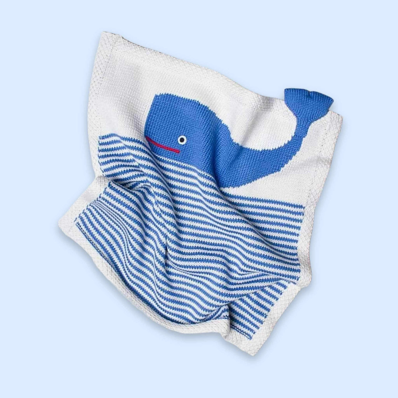 Organic baby gift set featuring a whale lovey, rattle, and striped hat