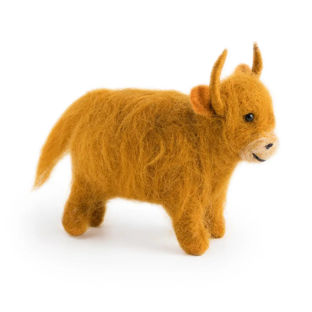 Brown plush toy of a cow on a white background