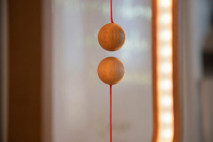Heng Balance Lamp is controlled by two wooden spheres. When you lift the lower wooden sphere, it will be attracted by the hanging one and remain suspended in mid-air, switching on the light. It is not a source of light, but also a piece of art. The gentle curve makes it easy to the eye and calming. The outside frame of the lamp is made of beech, making it natural and warm to the touch. Red Dot Award Winner