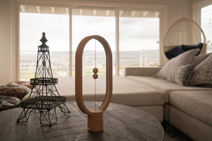 Heng Balance Lamp is controlled by two wooden spheres. When you lift the lower wooden sphere, it will be attracted by the hanging one and remain suspended in mid-air, switching on the light. It is not a source of light, but also a piece of art. The gentle curve makes it easy to the eye and calming. The outside frame of the lamp is made of beech, making it natural and warm to the touch. Red Dot Award Winner