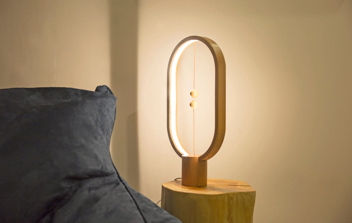 Heng Balance Lamp is controlled by two wooden spheres. When you lift the lower wooden sphere, it will be attracted by the hanging one and remain suspended in mid-air, switching on the light. It is not a source of light, but also a piece of art. The gentle curve makes it easy to the eye and calming. The outside frame of the lamp is made of beech, making it natural and warm to the touch. Red Dot Award Winner