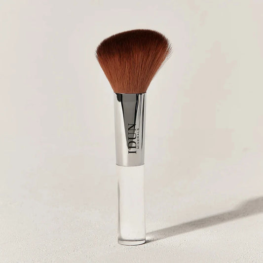 IDUN Minerals Blush Bronzer Brush with angled bristles and a silver-colored handle, and a clear handle. 