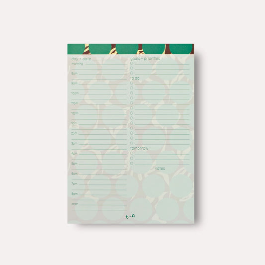 Notepad with a green border and white grid on a light gray background