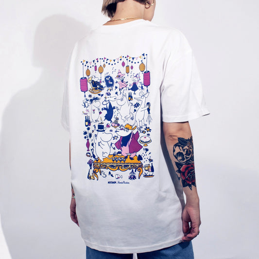 Person wearing a white t-shirt with colorful graphic design on a plain background