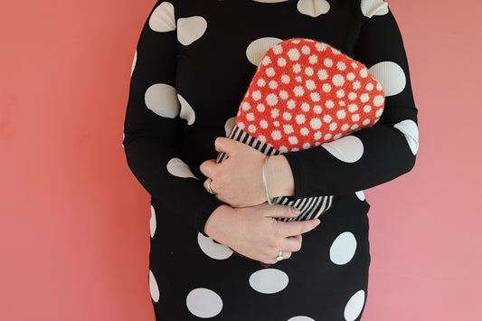 Cosy up with with this dotty Mushroom Hot Water Bottle. Use this hot water bottle with a knitted cover to keep warm on a chilly evening or to soothe your aches and pains.
