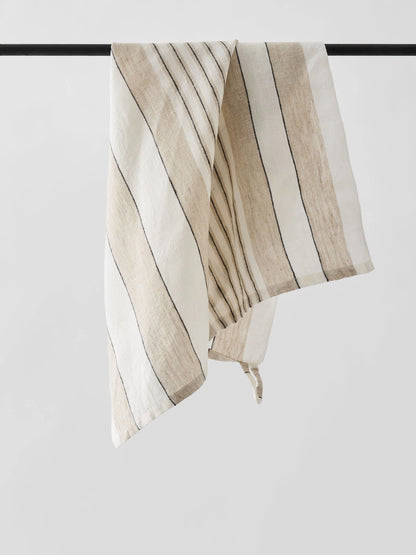 Striped fabric with beige and white stripes on a black rod against a white background