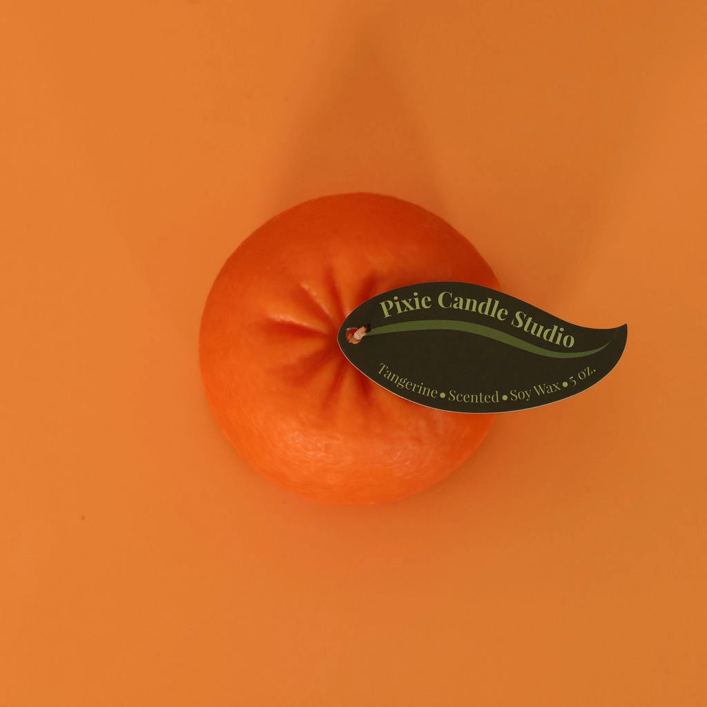 Orange candle with a label on an orange background