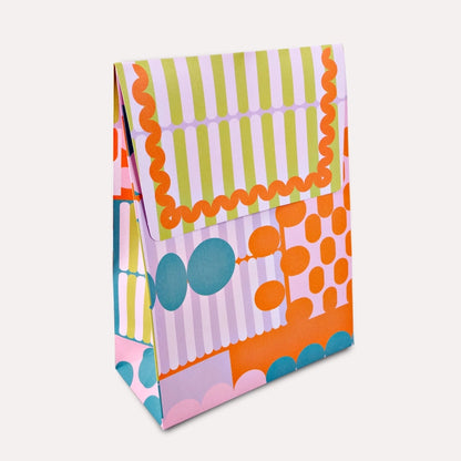 A flat gift bag that’s all edge, no filler. The Osaka print brings graphic punch and full-colour energy to your shelves—designed to stand out among the beige and boring. With a sturdy flat base and luxe paper feel, it’s the packaging equivalent of a statement outfit. Made from 120gsm FSC-certified paper and printed with soy-based inks, it’s as sustainable as it is good-looking. Ships flat for easy storage. It has double sided tape to secure the flap.&nbsp;