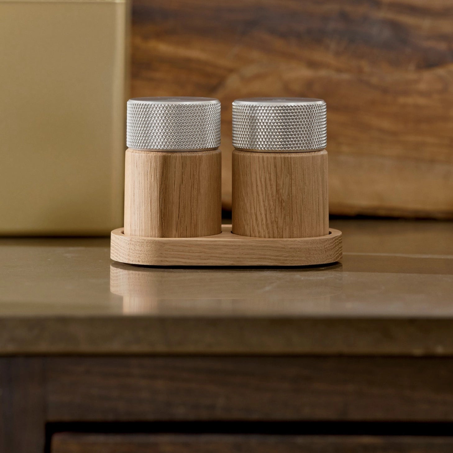 Wooden salt and pepper grinders made of oak and steel made in Denmark by the brand Gejst. They are high powered grinders that create a smooth fine grindand the natural oak grain against the textured steel provides a modern warm feel and look. Find at Huset Shop a Scandinavian Design store in Venice California