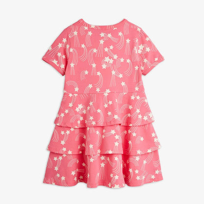Pink dress with white star and moon pattern on a white background