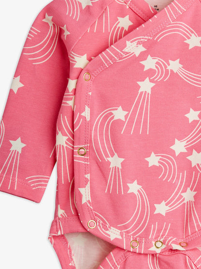 Pink shirt with white star and moon pattern on a white background