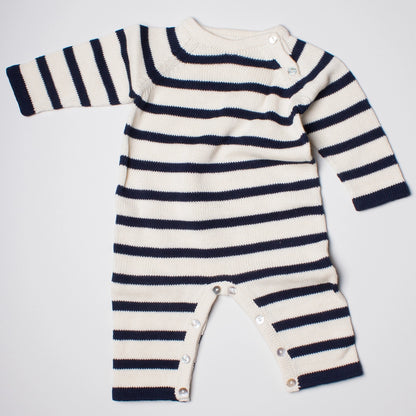 Striped baby romper with long sleeves on a light gray background