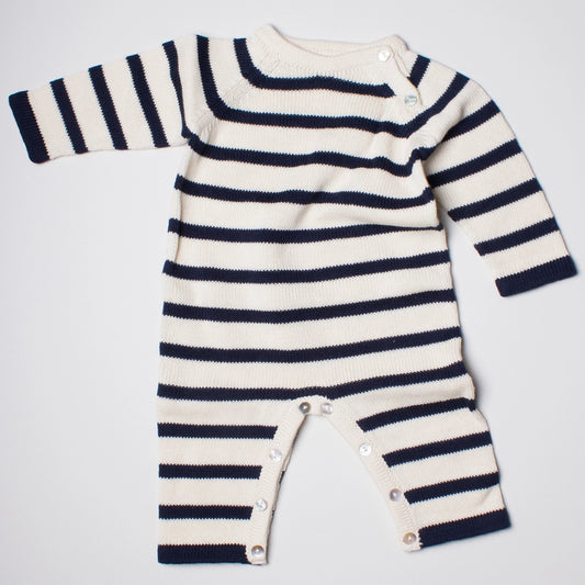 Striped baby romper with long sleeves on a light gray background