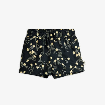 Black shorts with gold star and moon pattern on a white background