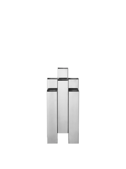 The Tessera Vase brings sculptural character to the home with its striking architectural form. Crafted from mirror-polished stainless steel, it catches and reflects light, adding a dynamic presence to a shelf, dining table, or sideboard. Designed to hold floral arrangements or stand alone as an object in its own right, the vase offers a thoughtful balance of form and function.