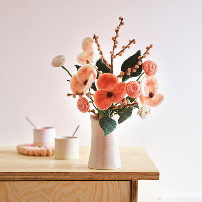 Aveva Wool Flower Bouquets that spark joy and will last you a lifetime. No more having to re buy flowers to fill the empty vases around your home, you can bring a touch of nature inside with colorful bouquets made with sustainable wool. This is the tokyo bouquet in a vase on display.