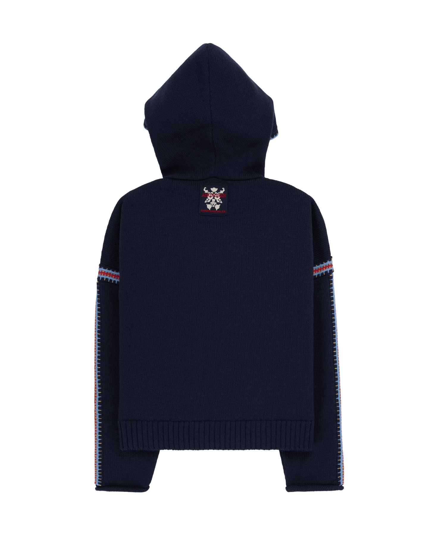 Two women sitting in a snowy landscape, wearing embroidered clothing, a true tribute to Norwegian heritage. This hooded sweater is crafted from 100% Norwegian wool, sourced from free-ranging sheep, and features embroidered motifs inspired by the traditional Norwegian Bunad of Telemark, Hallingdal, and Gudbrandsdalen.