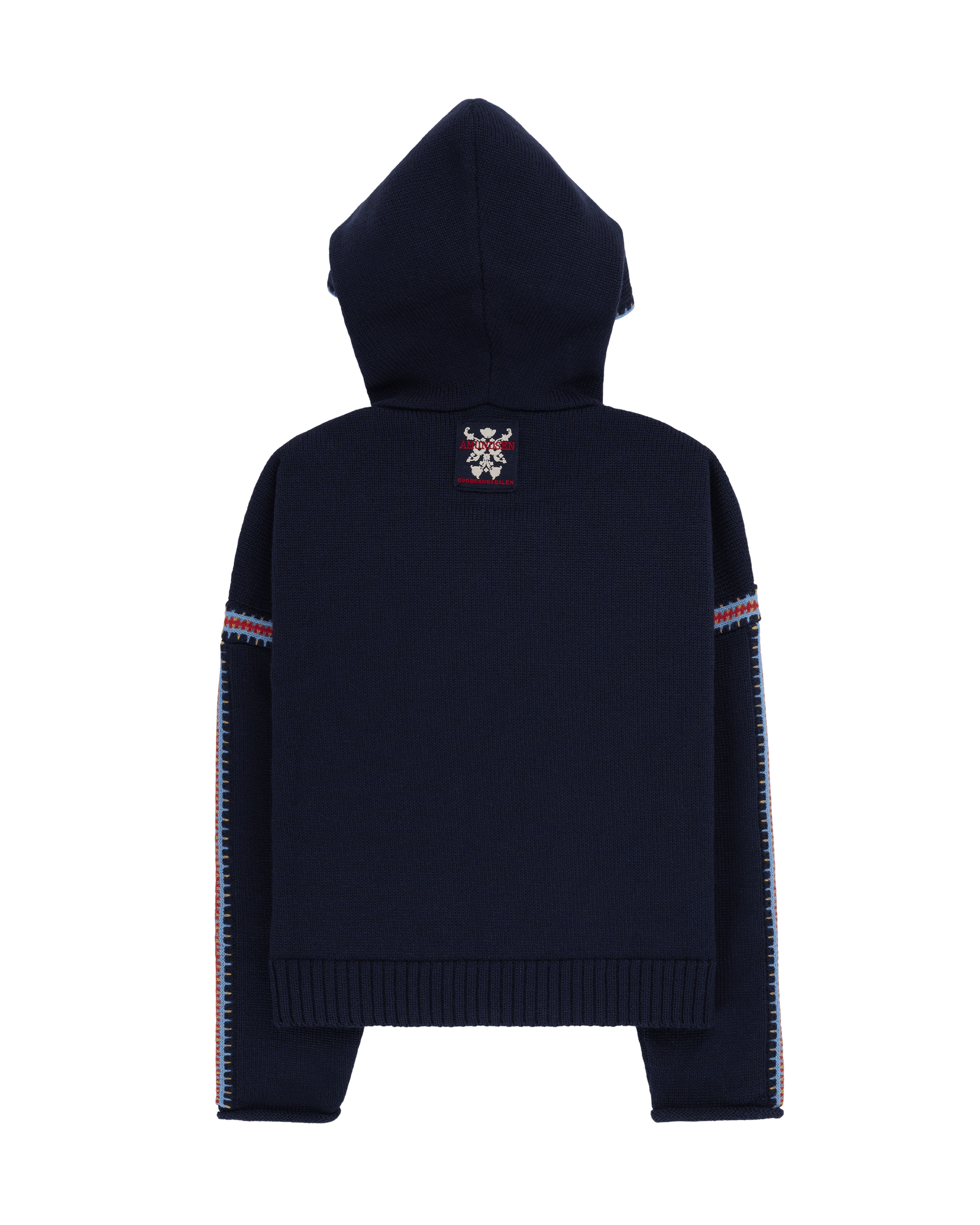 Two women sitting in a snowy landscape, wearing embroidered clothing, a true tribute to Norwegian heritage. This hooded sweater is crafted from 100% Norwegian wool, sourced from free-ranging sheep, and features embroidered motifs inspired by the traditional Norwegian Bunad of Telemark, Hallingdal, and Gudbrandsdalen.