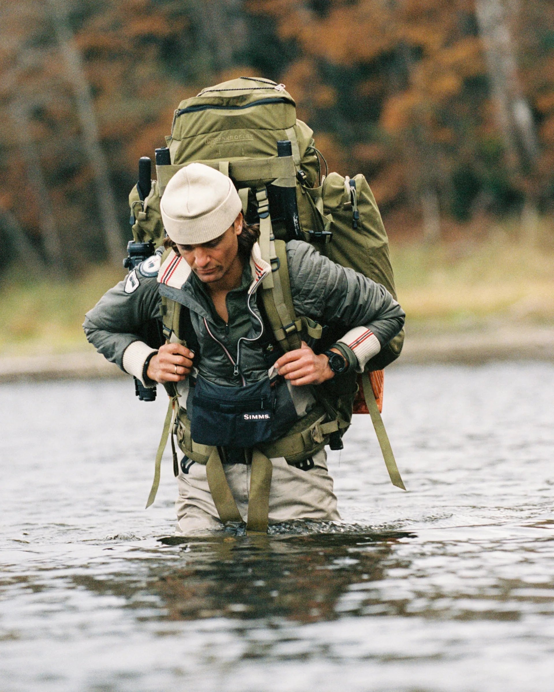 Norwegian camping or hiking, or anything involving the outdoors you will love this jacket. Lightweight durable polyamide face, 120 grams Norwegian Woolinside insulation, Cuffs, waist and neck knitted in pure merino wool, Antarctic Tartan lining
Amundsen Peak patches on upper sleeves. He is in a river going on a fun adventure and staying warm with his layer.